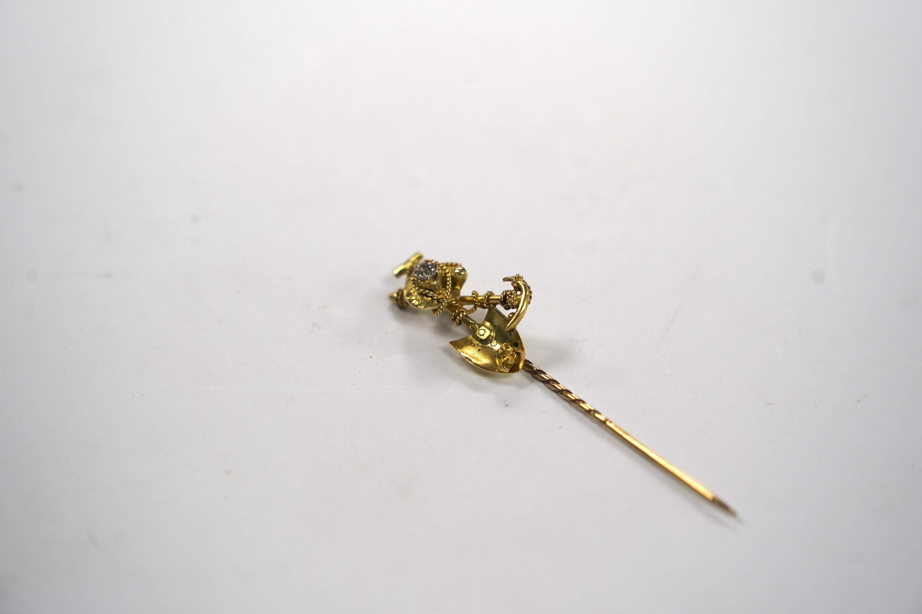 An early 20th century 9ct and diamond set 'Australian miner's' stick pin, 63mm, 4 grams.